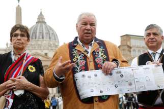David Chartrand, president of the Manitoba Métis Federation, holds a timeline as he speaks with journalists following a meeting of a Canadian Métis delegation with Pope Francis at the Vatican April 21, 2022.