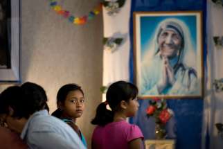 A young girl looks back during Mass being celebrated Aug. 21 at a new chapel of the Missionaries of Charity in Tijuana, Mexico. Blessed Teresa of Kolkata will be canonized Sept. 4 at the Vatican.
