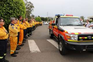 Firefighters line the road as a vehicle carrying the casket of volunteer firefighter Andrew O&#039;Dwyer passes en route to his funeral Mass at Our Lady of Victories Catholic Church in Sydney Jan. 7, 2020. O&#039;Dwyer, a member of the Horsley Park Rural Fire Brigade in Sydney, died Dec. 19 when the truck he was traveling in rolled off the road after a tree fell in the town of Buxton.