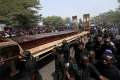 Men march along a truck Jan. 11 carrying the coffins of people killed by Fulani herdsmen in Makurdi, Nigeria. With at least 80 people killed since the start of the year in conflict over fertile land in Nigeria, the nation&#039;s bishops condemned what they call brutal massacres of innocent people.
