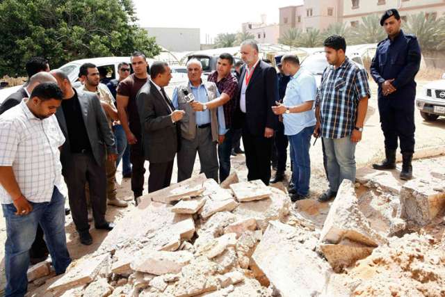Acting Libyan Prime Minister Abdullah al-Thinni, third from left in front, speaks to the media while visiting the Salah Eddin district after explosions took place at midnight May 21 in Tripoli.  An Islamist group has gained ground in the northeastern Libyan city of Benghazi, declaring it an Islamic territory.