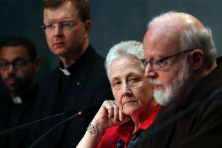 Marie Collins, center, then member of the Pontifical Commission for the Protection of Minors, watches as Cardinal Sean P. O&#039;Malley of Boston, president of the commission, speaks during a briefing at the Vatican May 3, 2014. Collins, who left the commission, told the Irish Times that Pope Francis &quot;should admit responsibility the Vatican and church leadership hold for past events in Ireland.&quot; Also pictured is Jesuit Father Hans Zollner, a professor of psychology and president of the Center for Child Protection at the Pontifical Gregorian University in Rome. 