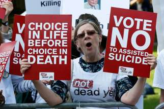 A demonstrator against &quot;assisted dying&quot; joins a protest outside the Houses of Parliament in London Sept. 11. Archbishop Peter Smith of Southwark has welcomed the overwhelming defeat of a bill to legalize assisted suicide in England and Wales.