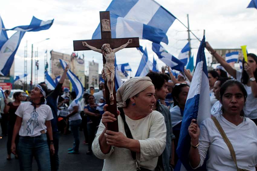  A demonstrator holds a crucifix during a protest against Nicaraguan President Daniel Ortega&#039;s government in Managua, Nicaragua, May 15. 