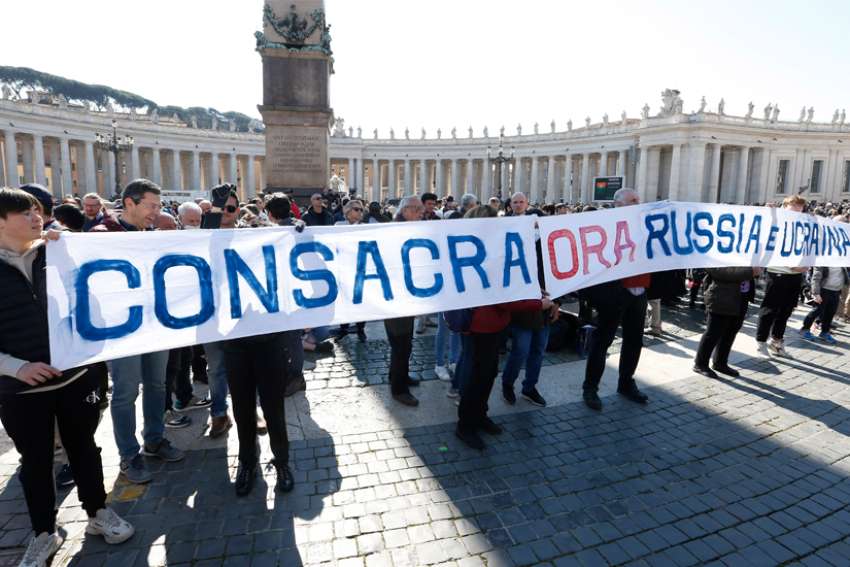 A sign in St. Peter&#039;s Square calls for the consecration of Russia and Ukraine to Mary, before the start of Pope Francis&#039; Angelus at the Vatican March 13, 2022. The Vatican said Pope Francis will consecrate Russia and Ukraine to the Immaculate Heart of Mary March 25.