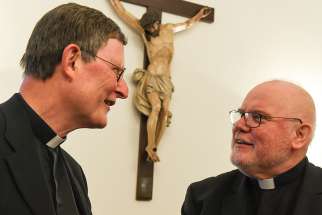 Cardinal Rainer Maria Woelki of Cologne, Germany, talks with Cardinal Reinhard Marx of Munich and Freising, president of the German bishops&#039; conference, at the opening of the bishops&#039; plenary assembly in Fulda, Germany, Sept. 19, 2016. Cardinals Woelki and Marx disagree about whether the bishops&#039; conference has the authority to develop its own guidelines about non-Catholic spouses receiving Communion.