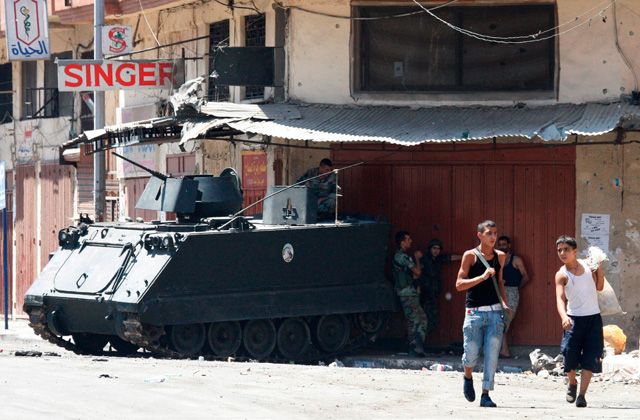 Children cross a street near a Lebanese army tank in the Sunni area of Tripoli, Lebanon, Aug. 25. Several people were recently killed in Tripoli in sectarian clashes triggered by the conflict in neighbouring Syria. Pope Benedict XVI is set to visit Beirut Sept. 14-16.
