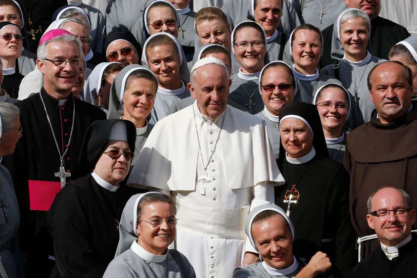 Pope Francis poses with clergy and women religious during his general audience in St. Peter&#039;s Square at the Vatican Oct. 7, 2015. The Pope has appointed a panel of six women and six men to study women deacons 