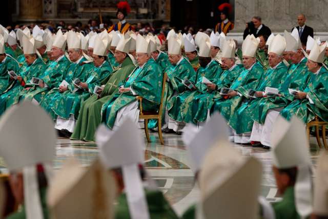 Prelates attend the opening Mass of the Synod of Bishops on the family celebrated by Pope Francis in St. Peter&#039;s Basilica at the Vatican Oct. 4. 