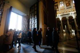 Pilgrims pass through the Holy Door of the Basilica of St. Paul Outside the Walls in Rome Dec. 13. U.S. Cardinal James M. Harvey, archpriest of the basilica, opened the Holy Door Dec. 13 as part of the Jubilee Year of Mercy.