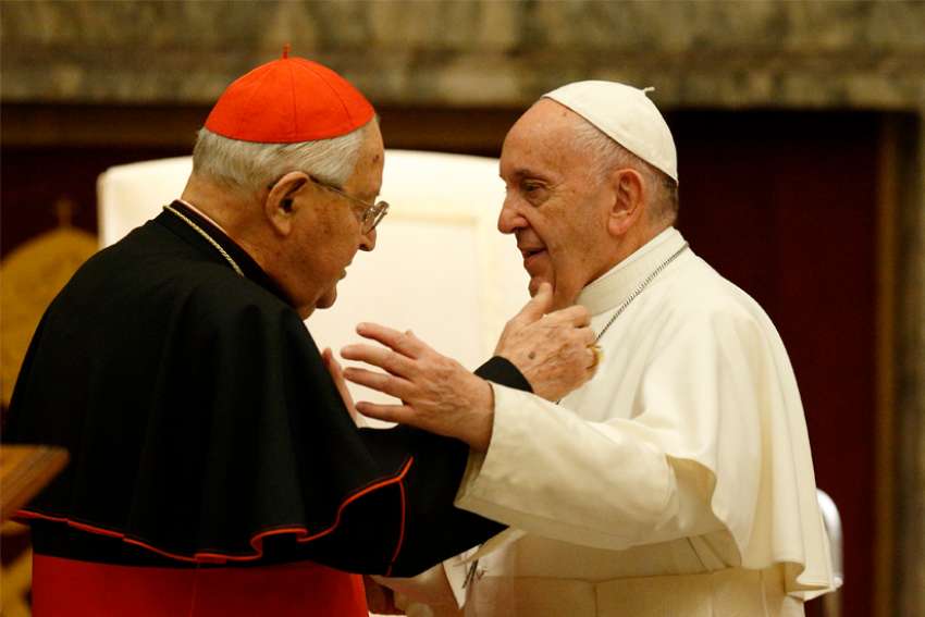 Pope Francis greets Cardinal Angelo Sodano, now dean emeritus of the College of Cardinals, during his annual audience to give Christmas greetings to members of the Roman Curia at the Vatican Dec. 21, 2019. The pope has accepted the resignation of Cardinal Sodano as dean of the College of Cardinals. The pope changed the norms to specify that the dean would be elected to a five-year term, renewable once, instead of being elected for life or until choosing to resign.