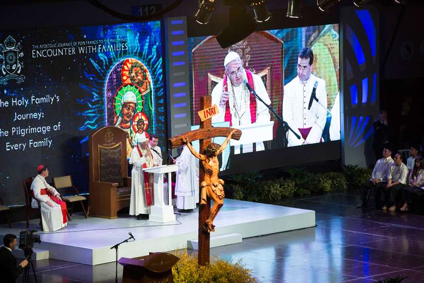Pope Francis and Cardinal Luis Antonio Tagle of Manila, Philippines, are seen on a big screen during a meeting with families at the Mall of Asia Arena in Pasay City, Philippines, Jan. 16.