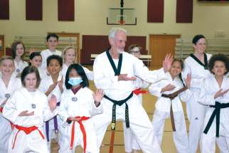 Fr. Guy Roberts instructs St. Barnabas School students in Indianapolis in taekwondo. Roberts, a black belt in taekwondo, is pastor of St. Barnabas Parish.