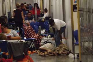 Some of the estimated 4,000 people prepare to spend the night at Largo High School as Hurricane Irma bore down on Largo, Fla., Sept. 9.