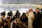 Pope Francis answers questions from journalists aboard the papal flight from Seoul, South Korea, to Rome Aug. 18.