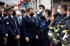 French President Emmanuel Macron talks with first responders outside Notre Dame Basilica in Nice Oct. 29, 2020, after at least three people were killed in a series of stabbings before Mass. France raised its alert level to maximum after the attack.