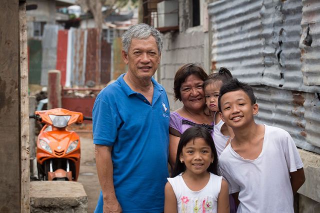 Emmanuel and Maria Rosevilla Margate pose for a photo with family members outside their home in Tacloban, Philippines, Feb. 10. The family huddled together in their block home Nov. 8, 2013, as Typhoon Haiyan made shambles of many homes in their community known as Barangay 54A.