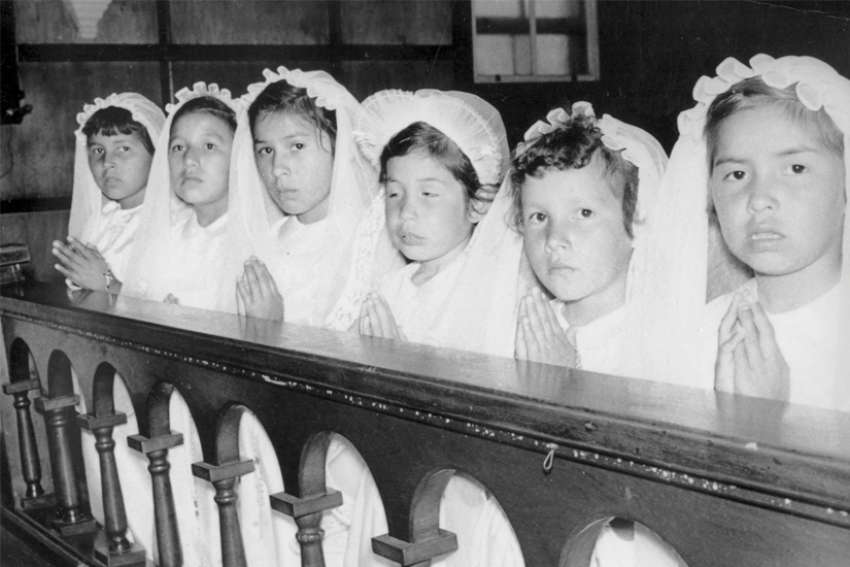  Indigenous girls attend a first Communion ceremony at the Spanish Indian Residential School in Ontario in 1955. The discovery of unmarked graves at various residential schools has sparked a renewed effort to raise funds for reconciliation efforts, including from a group of lay Catholics.
