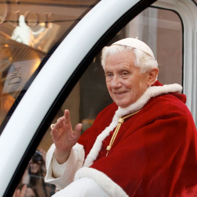 Pope Benedict XVI greets the crowd as he travels in the popemobile to the Spanish Steps for a ceremony honoring Mary in Rome Dec. 8. The annual ceremony marks the feast of the Immaculate Conception.