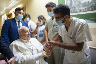 Pope Francis greets hospital workers at Gemelli hospital in this file photo taken in Rome July 11, 2021, when the pope had been in the hospital for 10 days to recover from a scheduled colon surgery.