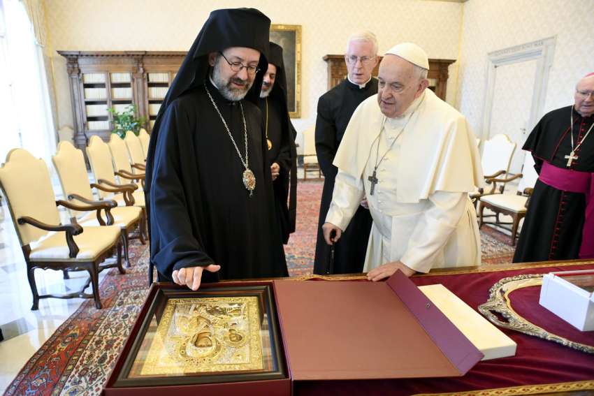 Orthodox Metropolitan Job of Pisidia, representing the Orthodox Ecumenical Patriarchate of Constantinople, points to an icon during a meeting with Pope Francis at the Vatican June 30, 2023.