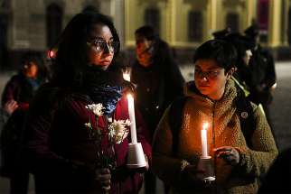 Demonstrators hold candles and flowers Aug. 20 in front of the Metropolitan Cathedral of Santiago, Chile. The demonstration was held as a protest against sexual abuse committed in the Chilean Catholic Church, in an event organized by the Network of Survivors of Ecclesiastical Abuse in Chile. 
