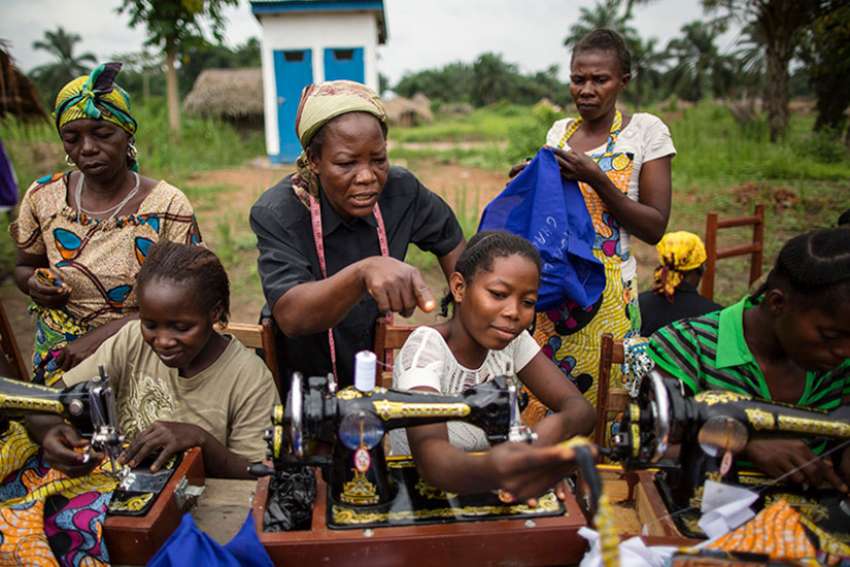 Sister Angélique Namaika, standing, in black, assists women with the clothes they are making at the Maison de La Femme in the town of Dungu, Orientale Province, Democratic Republic of Congo, on Aug. 1, 2013.