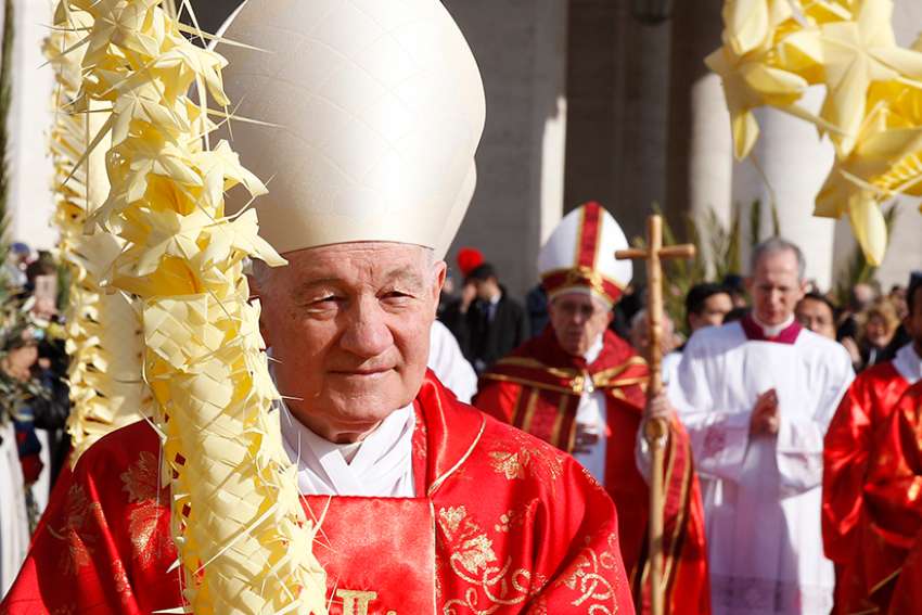 Canadian Cardinal Marc Ouellet, prefect of the Congregation for Bishops, walks in procession ahead of Pope Francis at the start of Palm Sunday Mass in St. Peter&#039;s Square at the Vatican March 25. 