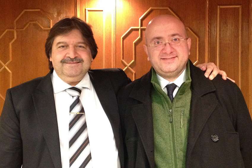 Italian Catholic cathedral organist Eugenio Maria Fagiani, right, poses with Syrian Culture Minister Mohammed Al-Ahmed, after Fagiani performed Feb. 9 with the Syrian National Symphony Orchestra at the Damascus Opera House.