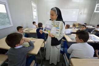 Dominican Sister Lemia Atala instructs students at the Al Bishara School in Ankawa, Iraq, April 7. The Islamic State group displaced the students and the Dominican Sisters in 2014.