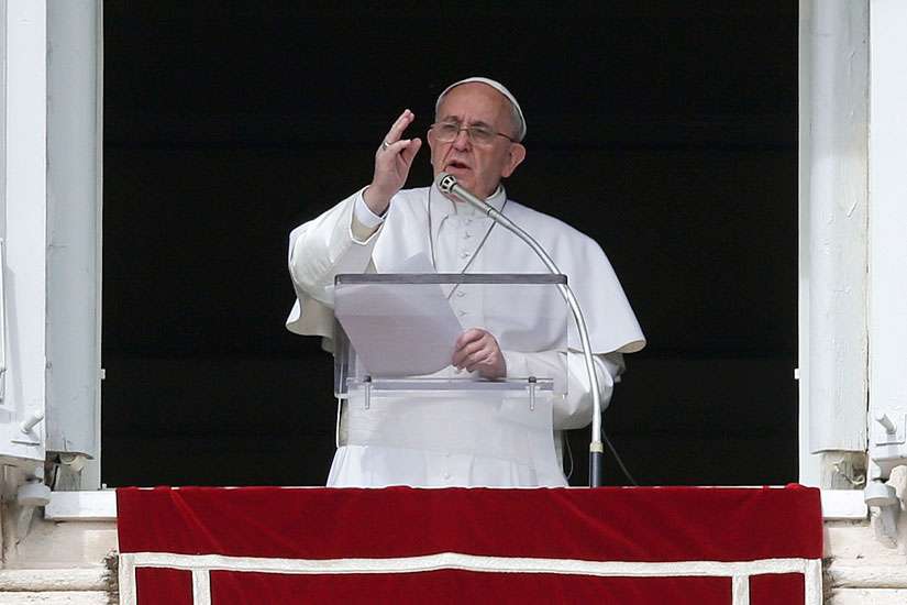 Pope Francis gives a blessing as he leads the Angelus from the window of the Apostolic Palace in St. Peter&#039;s Square at the Vatican Feb. 22. 