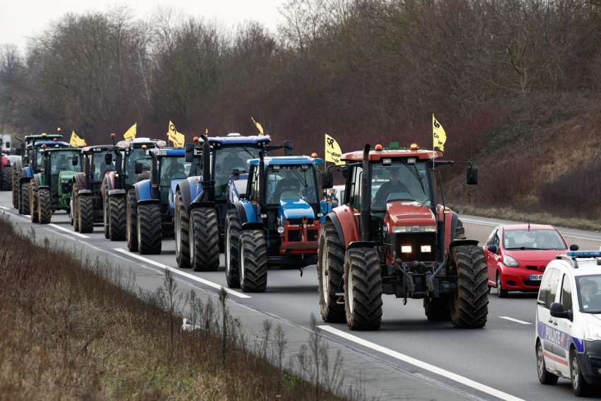 French farmers drive their tractors in a go-slow operation in Compans near Roissy Charles-de-Gaulle Airport Jan. 27, 2024, in a protest over price pressures, taxes and green regulation, grievances shared by farmers across Europe.