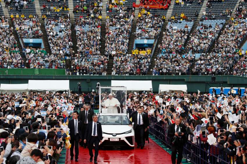 Pope Francis greets the crowd before celebrating Mass at the baseball stadium in Nagasaki, Japan, Nov. 24, 2019.