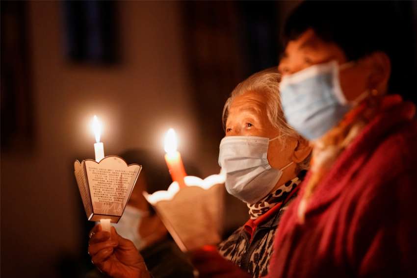 Worshippers wearing protective masks pray during the Easter Vigil at a church in Shanghai April 3, 2021, during the COVID-19 pandemic. Fears are rising over China&#039;s looming rising crackdown on Catholic and Protestant church leaders that authorities deem illegal.