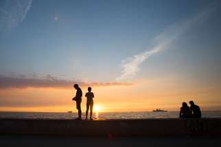 People enjoy the sunset on Manila Bay, Philippines, in this Jan. 20, 2015, file photo. The quincentenary that marks the introduction of Roman Catholicism in the Philippines cannot go unnoticed, given the impact and influence that Catholicism has and continues to have in the everyday lives of Filipinos.