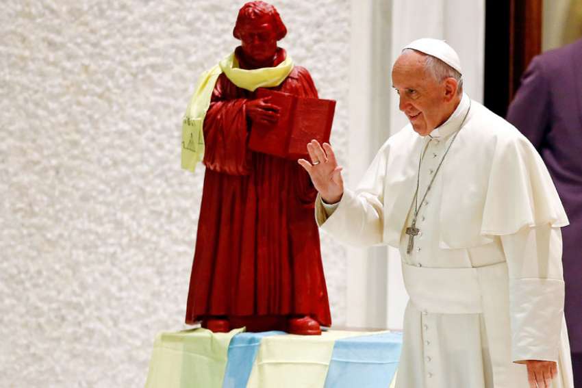  A statue of Martin Luther is seen onstage as Pope Francis arrives for an audience with a pilgrimage of Catholics and Lutherans from Germany in the Paul VI hall at the Vatican Oct. 13. The pope will visit Sweden Oct. 31-Nov. 1 for commemorations of the 500th anniversary of the Protestant Reformation.