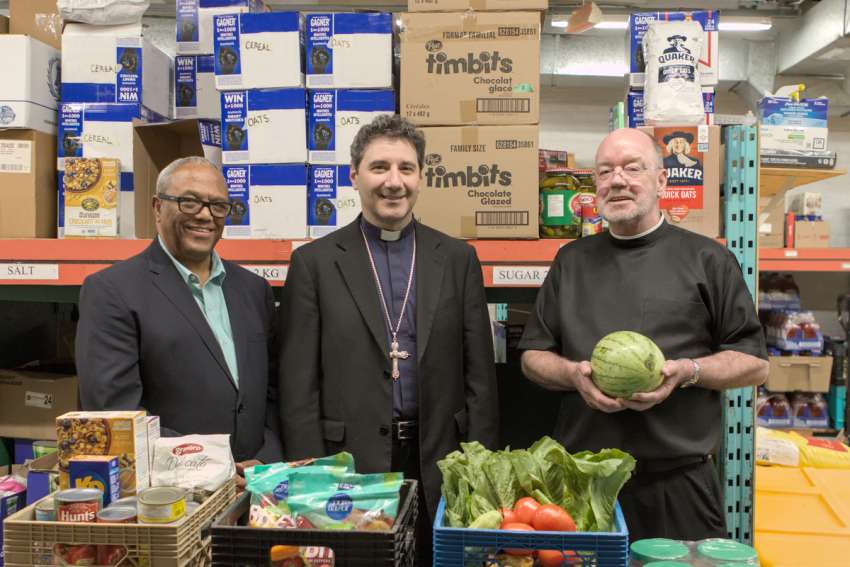 From left, Aklilu Wendaferew, executive director of Good Shepherd Ministries, Archbishop Francis Leo and The Good Shepherd’s Br. David Lynch announce a $520,000 commitment to fight food insecurity.