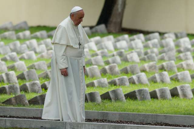 Pope Francis walks through the Austro-Hungarian cemetery for soldiers of World War I in Fogliano di Redipuglia, Italy, Sept. 13. The pope prayed for the fallen of all wars and also celebrated an outdoor Mass in front of the nearby Redipuglia war memorial , which honors the 100,000 Italian soldiers who died during World War I.