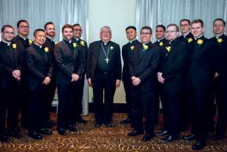 Cardinal Thomas Collins poses with the graduating class from St. Augustine’s Seminary in March. Eight men will be ordained in Toronto June 27.