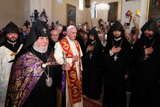 Catholicos Karekin II, patriarch of the Armenian Apostolic Church, and Pope Francis arrive to visit the Armenian Apostolic Cathedral at Etchmiadzin in Vagharshapat, Armenia, June 24.