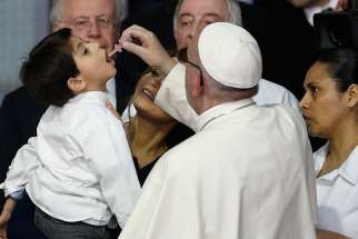 Pope Francis gives a vaccine to a boy held by Mexico&#039;s first lady Angelica Rivera during a visit to the Federico Gomez Children&#039;s Hospital of Mexico in Mexico City Feb. 14.