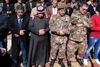Saif al-Kasasbeh, second from left, father of First Lt. Muath al-Kasasbeh, Jordanian pilot, prays in Jordan Feb. 4 with other mourners during an event commemorating the Islamic State murder of the pilot. 