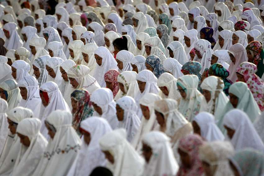 Indonesian Muslims are seen during Eid al-Fitr prayers to celebrate the end of Ramadan June 25 at Baiturrahman Grand Mosque in Banda Aceh. Indonesian Catholics have made a greater than usual effort to help Muslims celebrate Eid al-Fitr this year amid heightened religious tensions gripping the country.