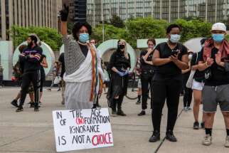 One of about 300 protesters gathered in Nathan Phillips Square June 5 had a message for people who choose not to pay attention to global protests.