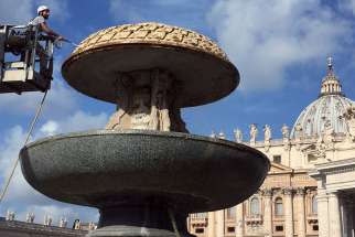 A Vatican worker cleans one of the fountains in St. Peter&#039;s Square July 25 after the Vatican turned off the water in the fountain to prevent waste as Rome considers water-rationing plans in the midst of a drought.