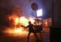 A pro-European Union protester throws an object during clashes with Ukrainian riot police in Kiev, Ukraine, Jan. 19. Ukrainian Catholic Church leaders appealed for calm as violent protests escalated after a government crackdown.
