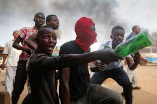 Protesters react to police officers firing shots toward them during an anti-government demonstration in late May in Bujumbura, Burundi. A Catholic aid worker in Burundi has said he believes &quot;outright conflict&quot; could still be avoided if the small East African country&#039;s rulers heed church appeals for dialogue and compromise.