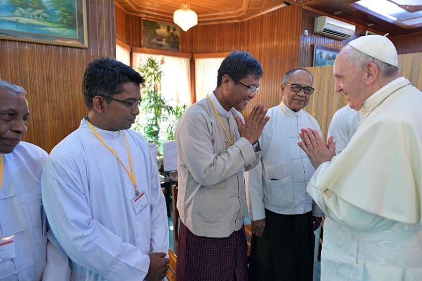 Pope Francis greets men during a small informal meeting with a variety of religious leaders Nov. 28 at the archbishop&#039;s residence in Yangon, Myanmar. 