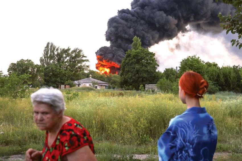 Residents in Donetsk, Ukraine, look on as smoke rises after shelling from Russia July 7. The world is lacking leaders who can deal with its problems and crises.