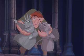 Quasimodo hugs his two gargoyle friends in Disney’s animated musical The Hunchback of Notre Dame.